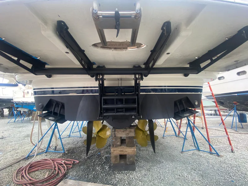 Slide: The Image of 2006 Viking Sport Cruisers 70 Motor Yacht under maintenance, showing propellers and hull. - 6