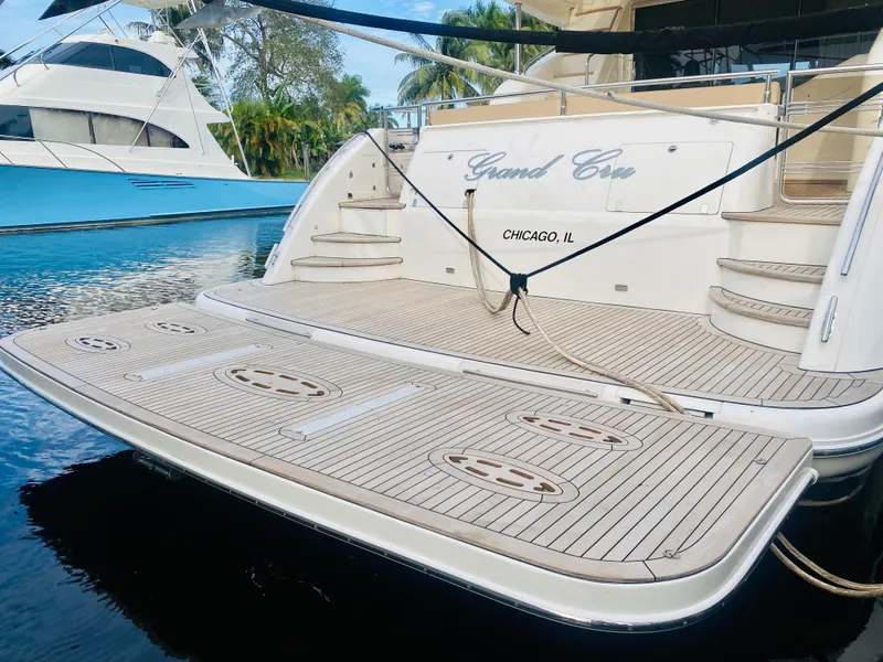 Slide: The Image of 2006 Viking Sport Cruisers 70 Motor Yacht docked, rear view with teak deck and Grand Cru name. - 9