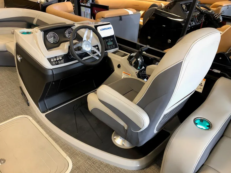 Slide: The Image of 2024 Barletta Cabrio 20Q boat cockpit with steering wheel and captain's chair. - 13