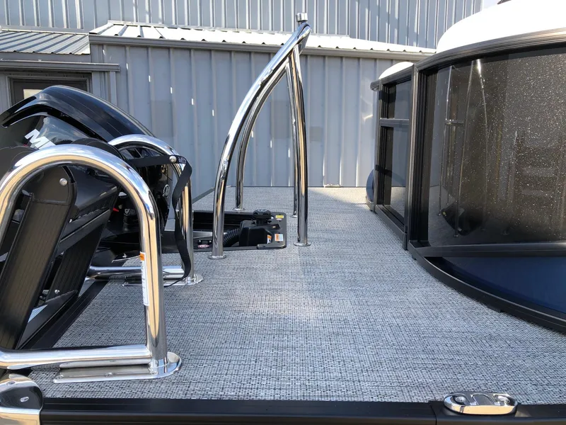 Slide: The Image of 2024 Barletta Cabrio 20Q pontoon boat deck with chrome railings and motor. - 4