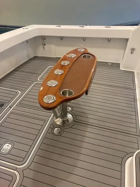 Slide: The Image of 2005 Viking 45 Open Express boat deck with rod holders and non-slip flooring. - 12