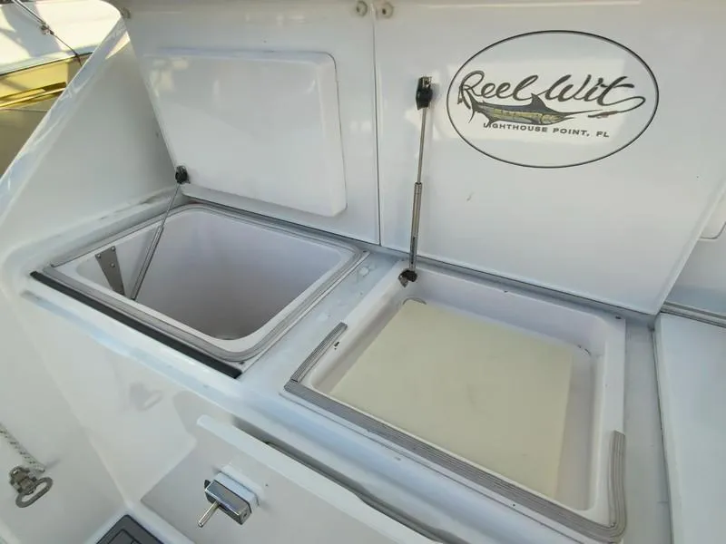 Slide: The Image of 2005 Viking 45 Open Express boat with open storage compartments and Reel Wit logo. - 14