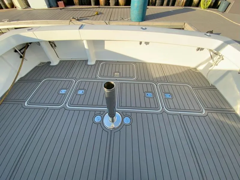 Slide: The Image of 2005 Viking 45 Open Express boat deck with storage hatches and central mount. - 17