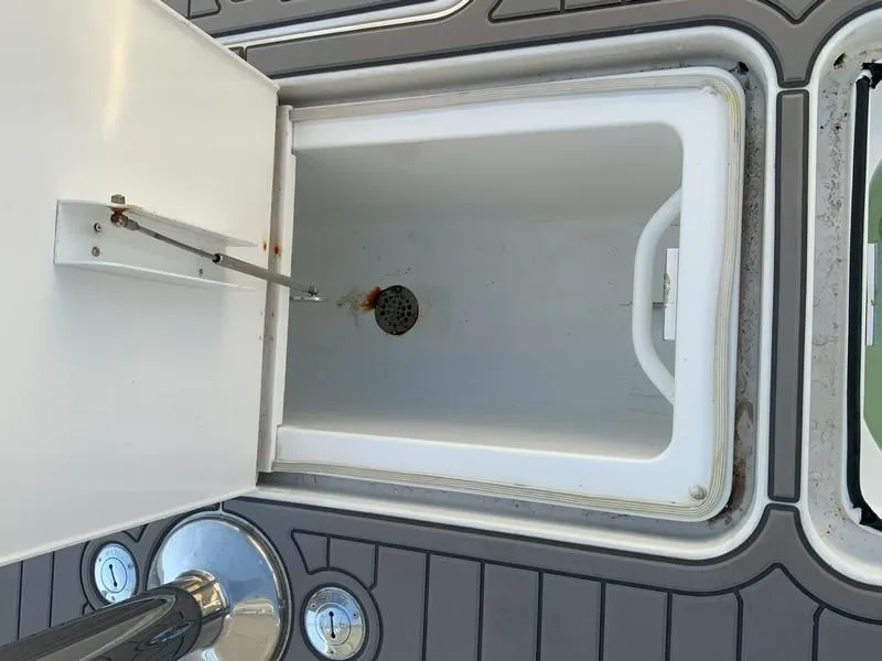 Slide: The Image of Open storage compartment on a 2005 Viking 45 Open Express boat. - 18