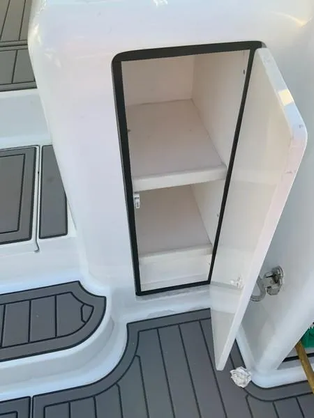 Slide: The Image of Open storage compartment on a 2005 Viking 45 Open Express boat. - 19