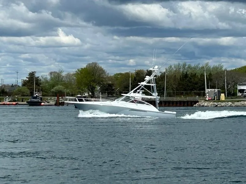 Slide: The Image of 2005 Viking 45 Open Express cruising on a cloudy day. - 2