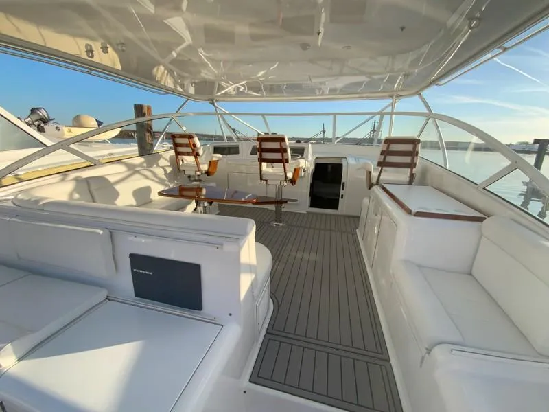 Slide: The Image of 2005 Viking 45 Open Express yacht interior with white seating and wooden accents. - 20