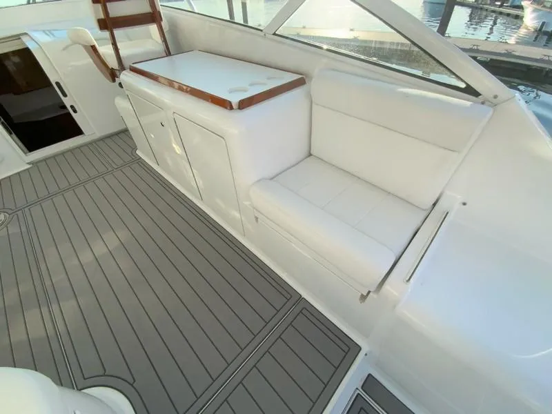 Slide: The Image of 2005 Viking 45 Open Express boat interior with white seating and gray flooring. - 22