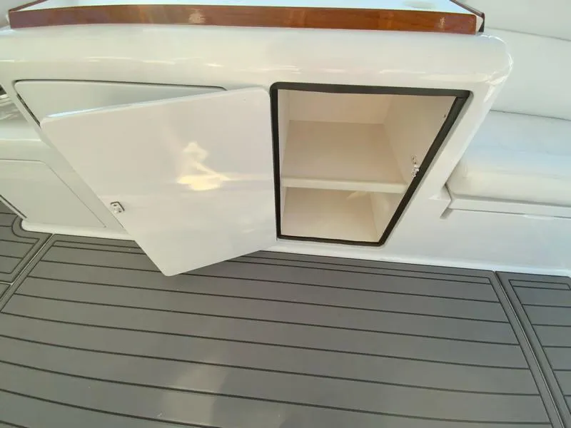 Slide: The Image of Open storage compartment on a 2005 Viking 45 Open Express boat. - 23