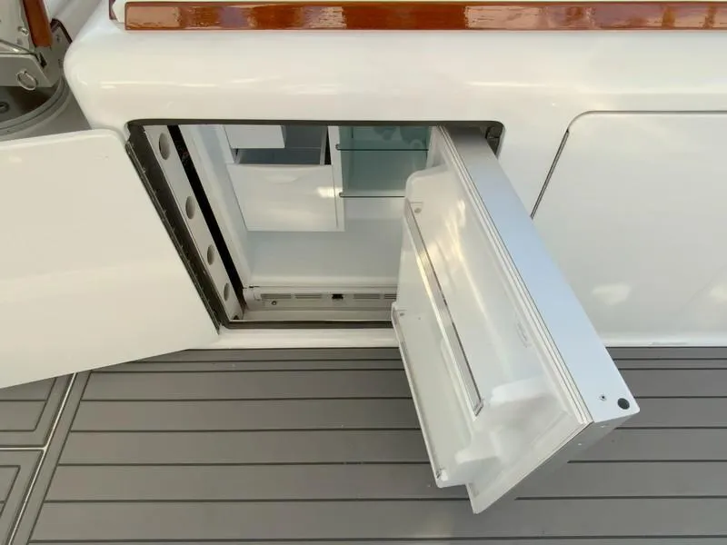 Slide: The Image of Open storage compartment on a 2005 Viking 45 Open Express boat. - 24