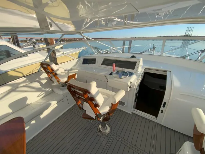 Slide: The Image of 2005 Viking 45 Open Express yacht cockpit with helm chairs and navigation equipment. - 26