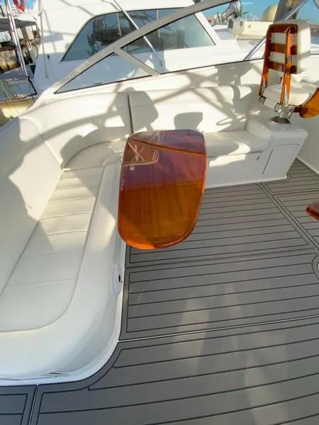 Slide: The Image of 2005 Viking 45 Open Express boat interior with white seating and wooden table. - 28