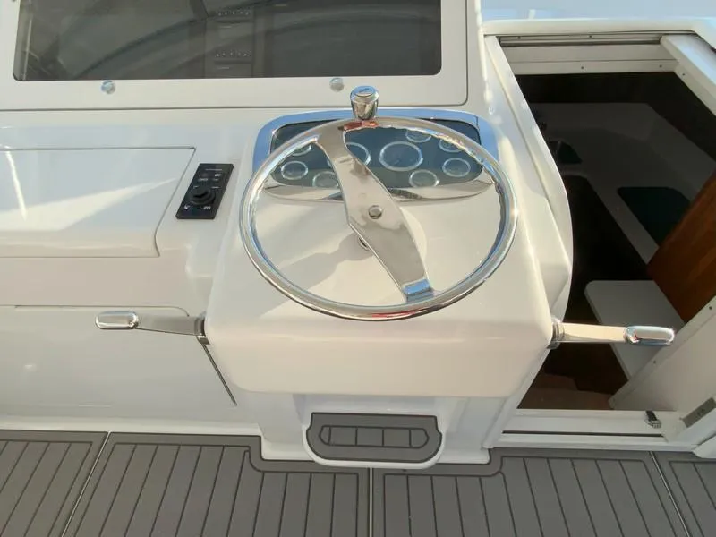 Slide: The Image of 2005 Viking 45 Open Express boat helm with steering wheel and control panel. - 31
