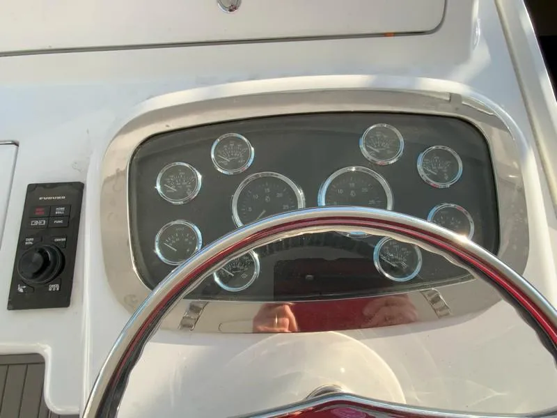 Slide: The Image of Dashboard of a 2005 Viking 45 Open Express boat with steering wheel and gauges. - 32