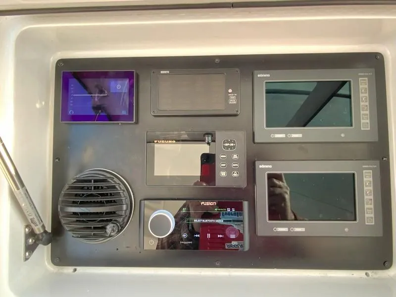 Slide: The Image of Control panel of a 2005 Viking 45 Open Express boat with various electronic displays. - 33