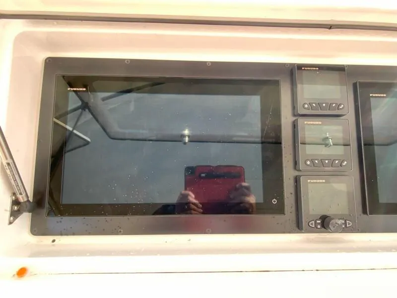 Slide: The Image of Control panel of a 2005 Viking 45 Open Express boat with electronic displays. - 34