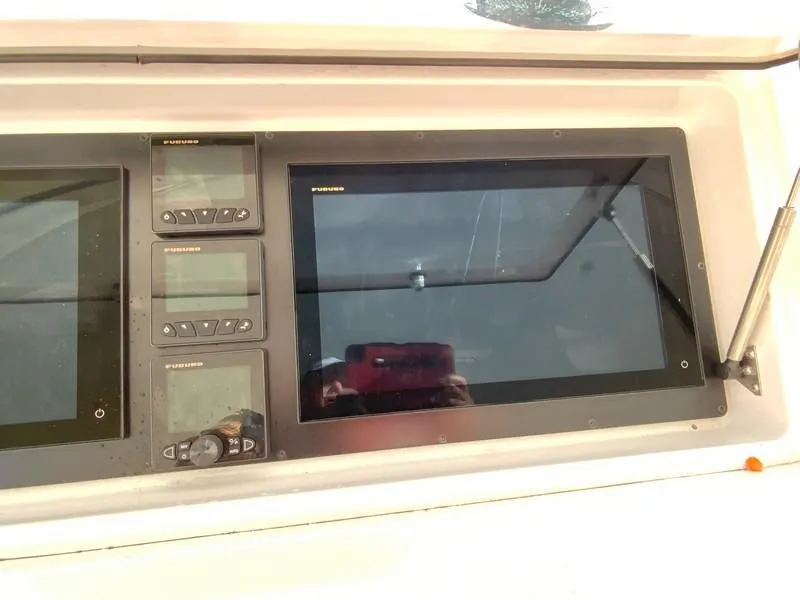 Slide: The Image of Control panel of a 2005 Viking 45 Open Express boat with navigation screens. - 35