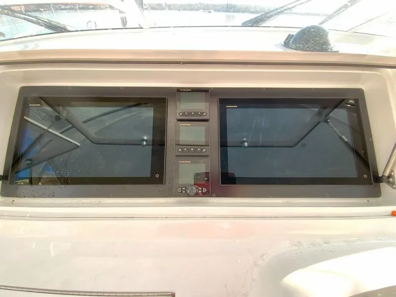 Slide: The Image of 2005 Viking 45 Open Express dashboard with dual screens and control panel. - 36