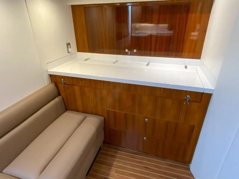 Slide: The Image of 2005 Viking 45 Open Express interior with wooden cabinetry and beige seating. - 44