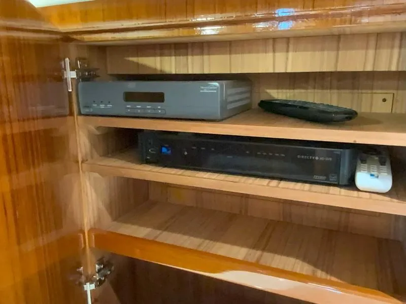 Slide: The Image of Wooden cabinet with electronic devices on a 2005 Viking 45 Open Express boat. - 46