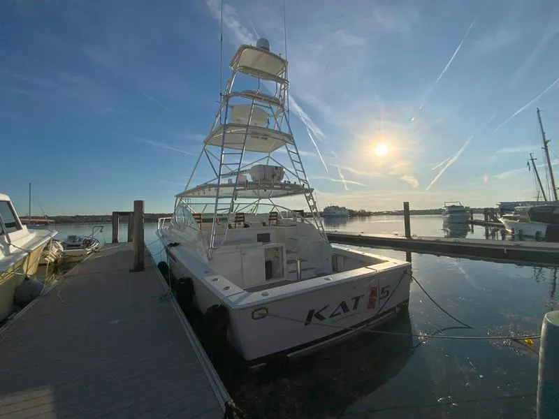 Slide: The Image of 2005 Viking 45 Open Express yacht docked at marina during sunset. - 7