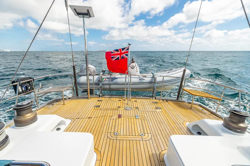 Slide: The Image of Deck view of 2011 Alia Yachts Warwick 82 LK with tender and ocean backdrop. - 11