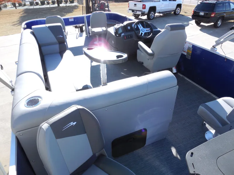 Slide: The Image of 2024 Bennington 20 SVF pontoon boat interior with gray seating and steering console. - 8