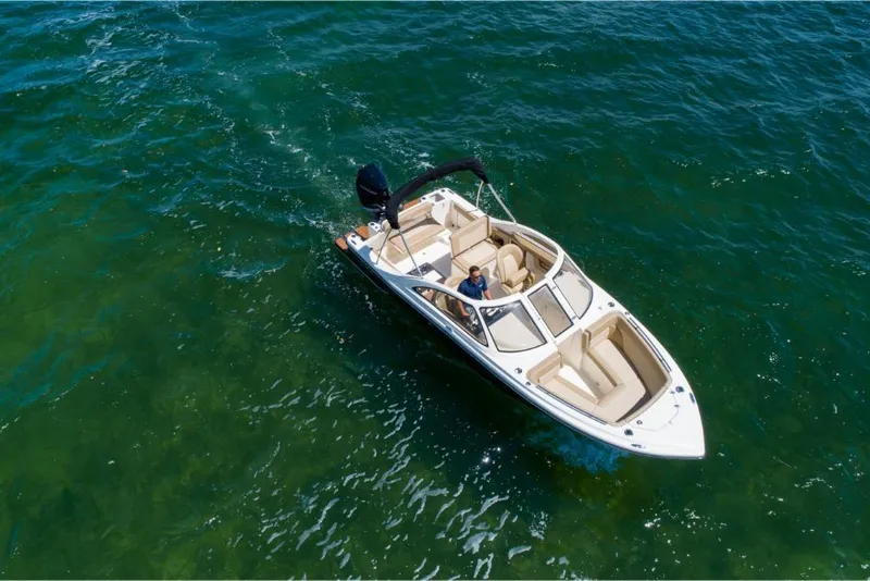 Slide: The Image of 2023 Scout 240 Dorado boat cruising on clear blue water. - 3