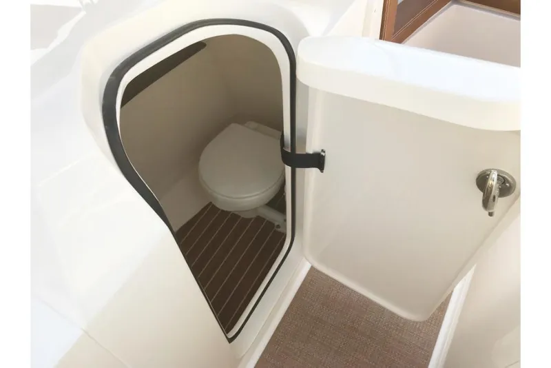 Slide: The Image of 2023 Scout 240 Dorado boat interior with compact marine toilet. - 43
