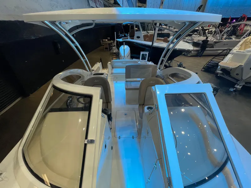 Slide: The Image of 2024 Scout 240 Dorado boat interior with blue LED lighting at a boat show. - 11