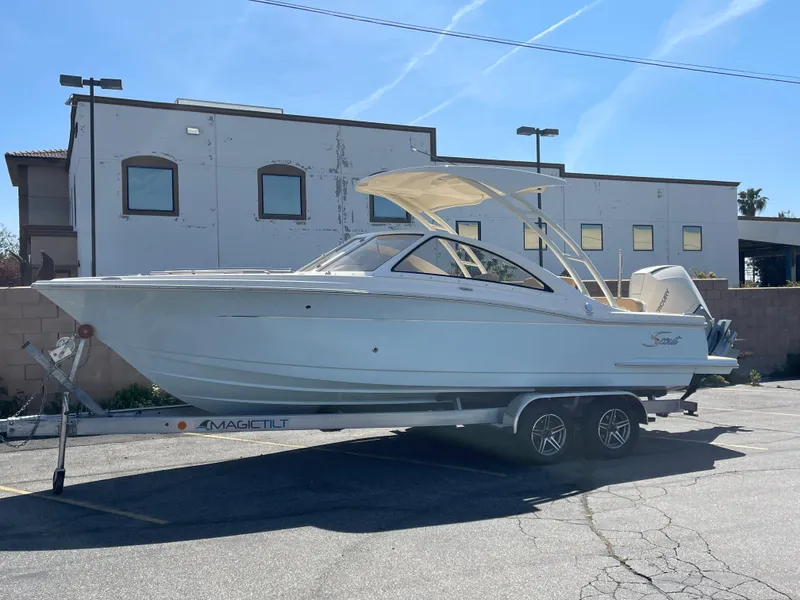 Slide: The Image of 2024 Scout 240 Dorado boat on trailer in parking lot. - 12