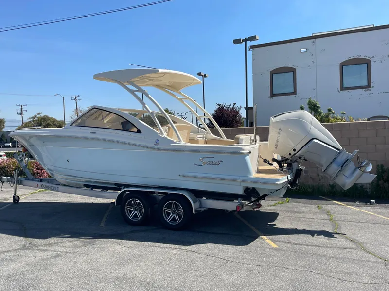 Slide: The Image of 2024 Scout 240 Dorado boat on trailer in parking lot, sunny day. - 13