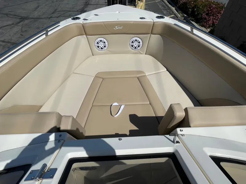 Slide: The Image of 2024 Scout 240 Dorado boat interior with beige seating and speakers. - 17