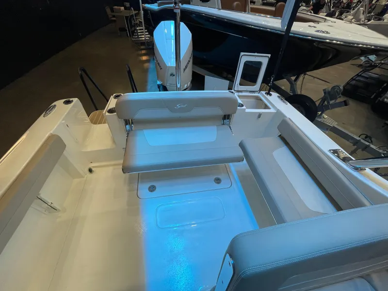 Slide: The Image of 2024 Scout 240 Dorado boat interior with seating and storage compartments. - 4