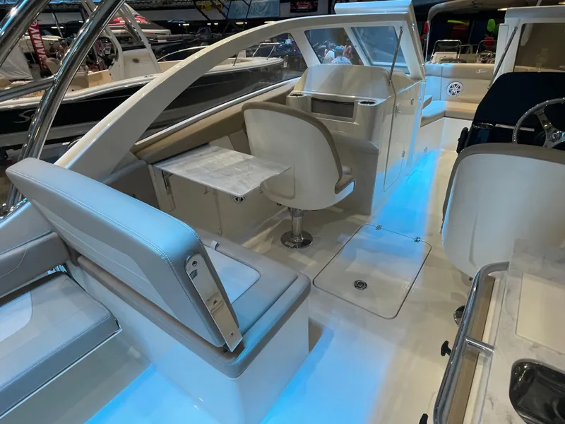 Slide: The Image of 2024 Scout 240 Dorado boat interior with seating and blue LED lighting. - 6