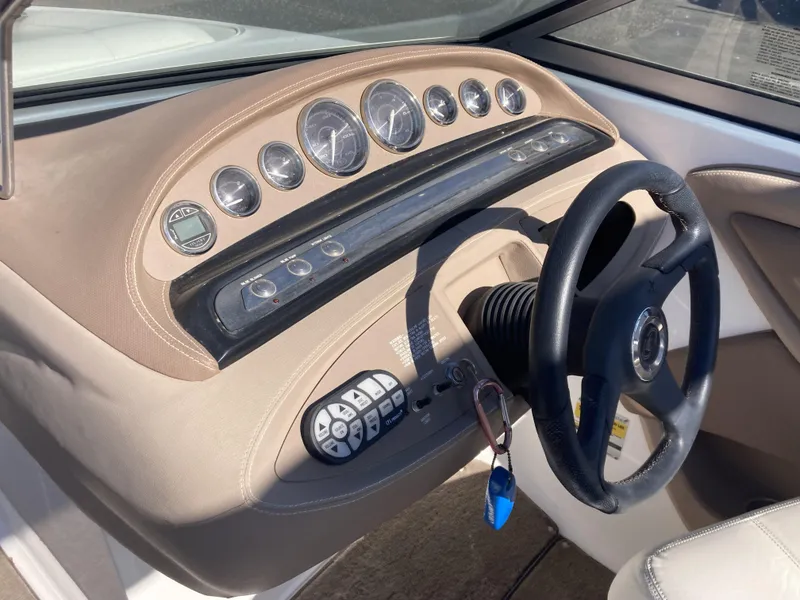 Slide: The Image of 2007 Cobalt 212 boat dashboard with steering wheel and instrument panel. - 16