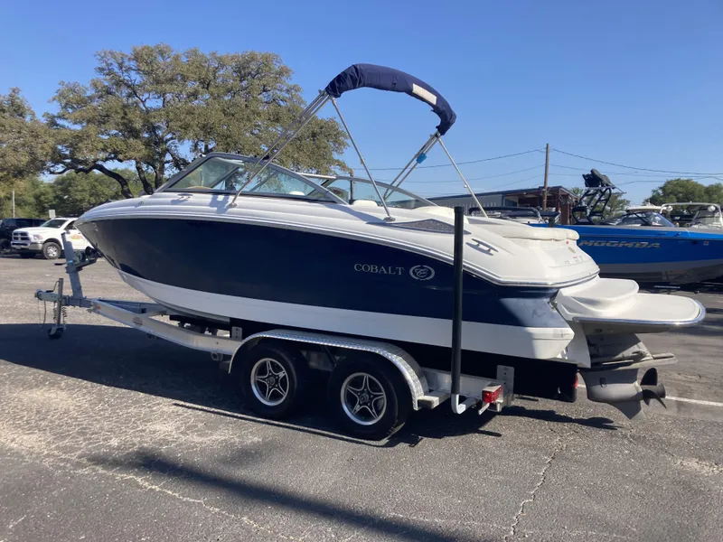 Slide: The Image of 2007 Cobalt 212 boat on trailer, parked outdoors under clear sky. - 3