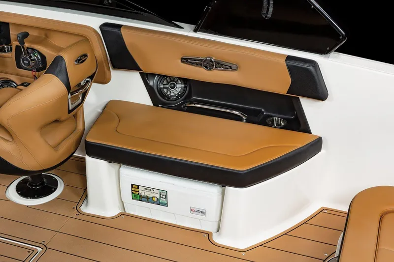 Slide: The Image of 2024 Chaparral 28 Surf boat interior with tan and black seating. - 10
