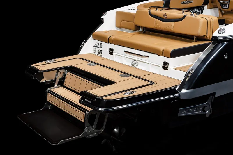 Slide: The Image of 2024 Chaparral 28 Surf boat with luxurious tan seating and sleek swim platform. - 14