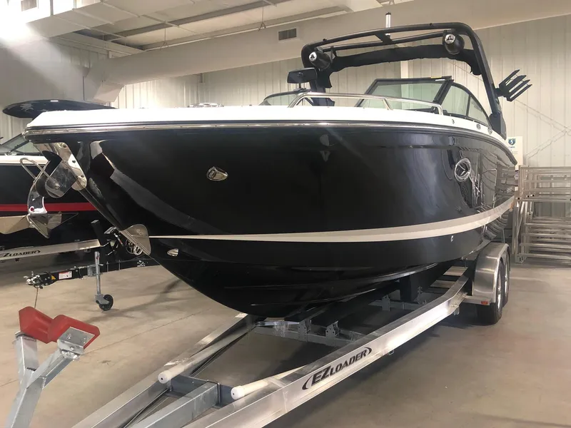 Slide: The Image of 2024 Chaparral 28 Surf boat on trailer in indoor showroom. - 3