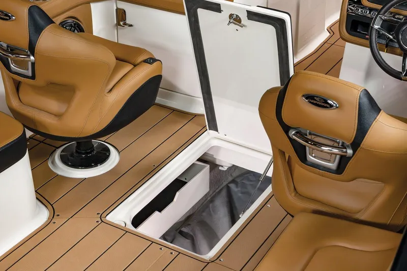 Slide: The Image of 2024 Chaparral 28 Surf interior with tan seats and open storage compartment. - 8