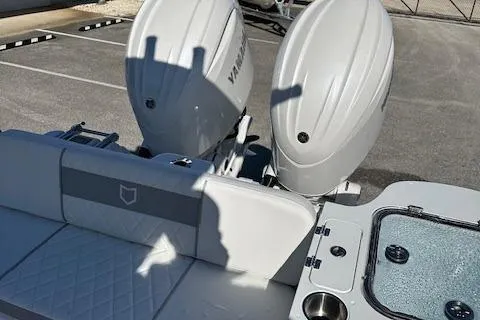 Slide: The Image of 2024 Sea Fox 268 Commander boat with dual outboard engines and cushioned seating. - 11