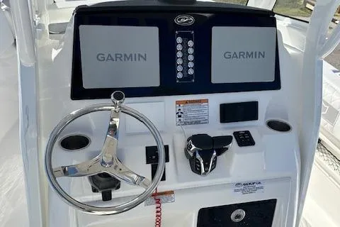 Slide: The Image of 2024 Sea Fox 268 Commander dashboard with dual Garmin displays and steering wheel. - 12