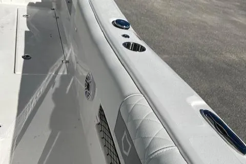 Slide: The Image of 2024 Sea Fox 268 Commander boat interior detail with cup holders and cushioned seating. - 7