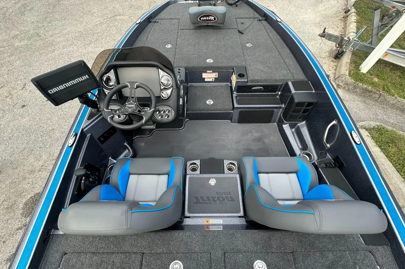 Slide: The Image of 2024 Triton 18 TrX fishing boat interior with dual seats and advanced navigation system. - 10