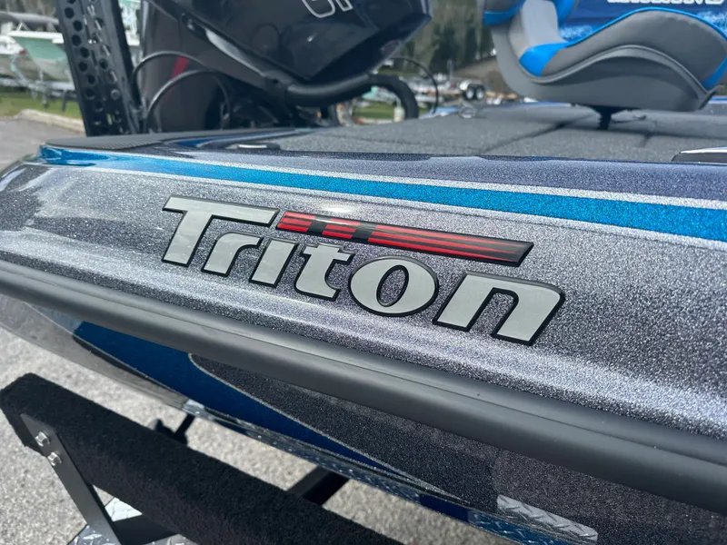 Slide: The Image of 2024 Triton 18 TrX boat close-up, showcasing logo and sleek design. - 3
