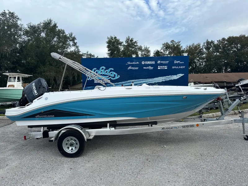 The Image of 2024 Hurricane SunDeck Sport 185 OB boat on a trailer, displayed outdoors. - 0