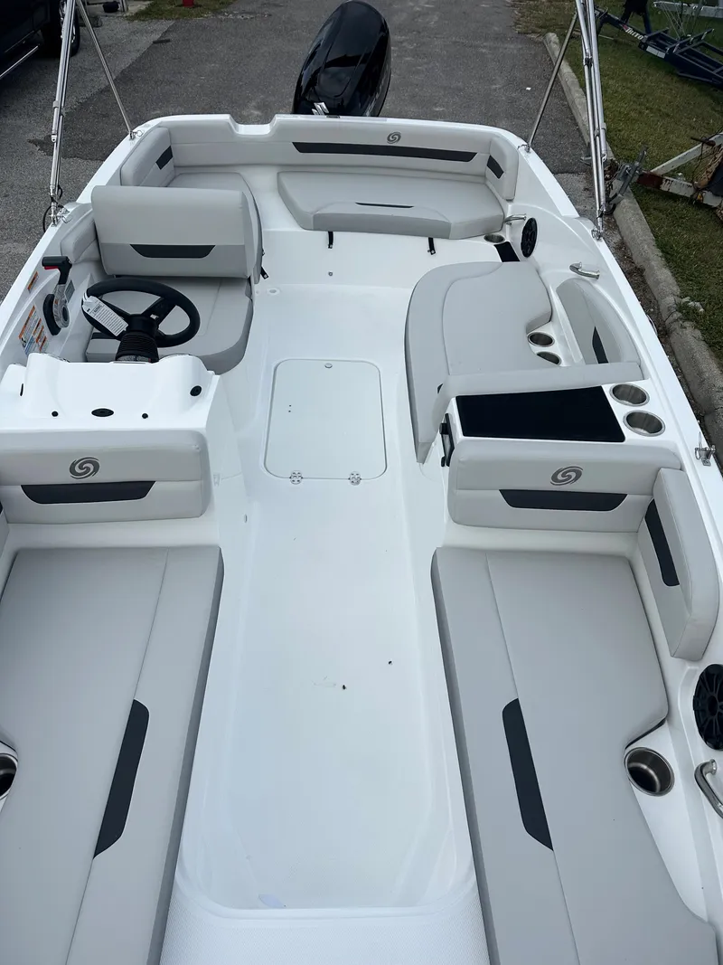 Slide: The Image of 2024 Hurricane SunDeck Sport 185 OB boat interior with seating and steering wheel. - 2