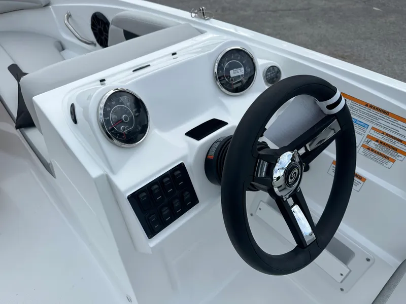 Slide: The Image of 2024 Hurricane SunDeck Sport 185 OB boat dashboard with steering wheel and gauges. - 5