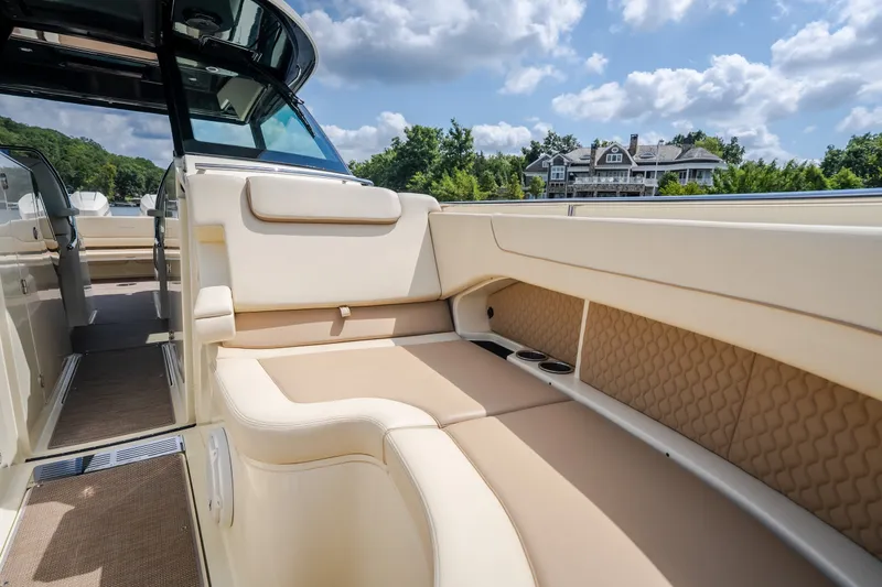 Slide: The Image of 2024 Chris-Craft Calypso 35 boat interior with luxurious seating and scenic background. - 53